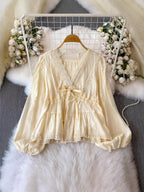 Lace detail v-neck blouse dress by Trendsi featuring elegant lace accents and a flattering v-neckline, displayed on a hanger.