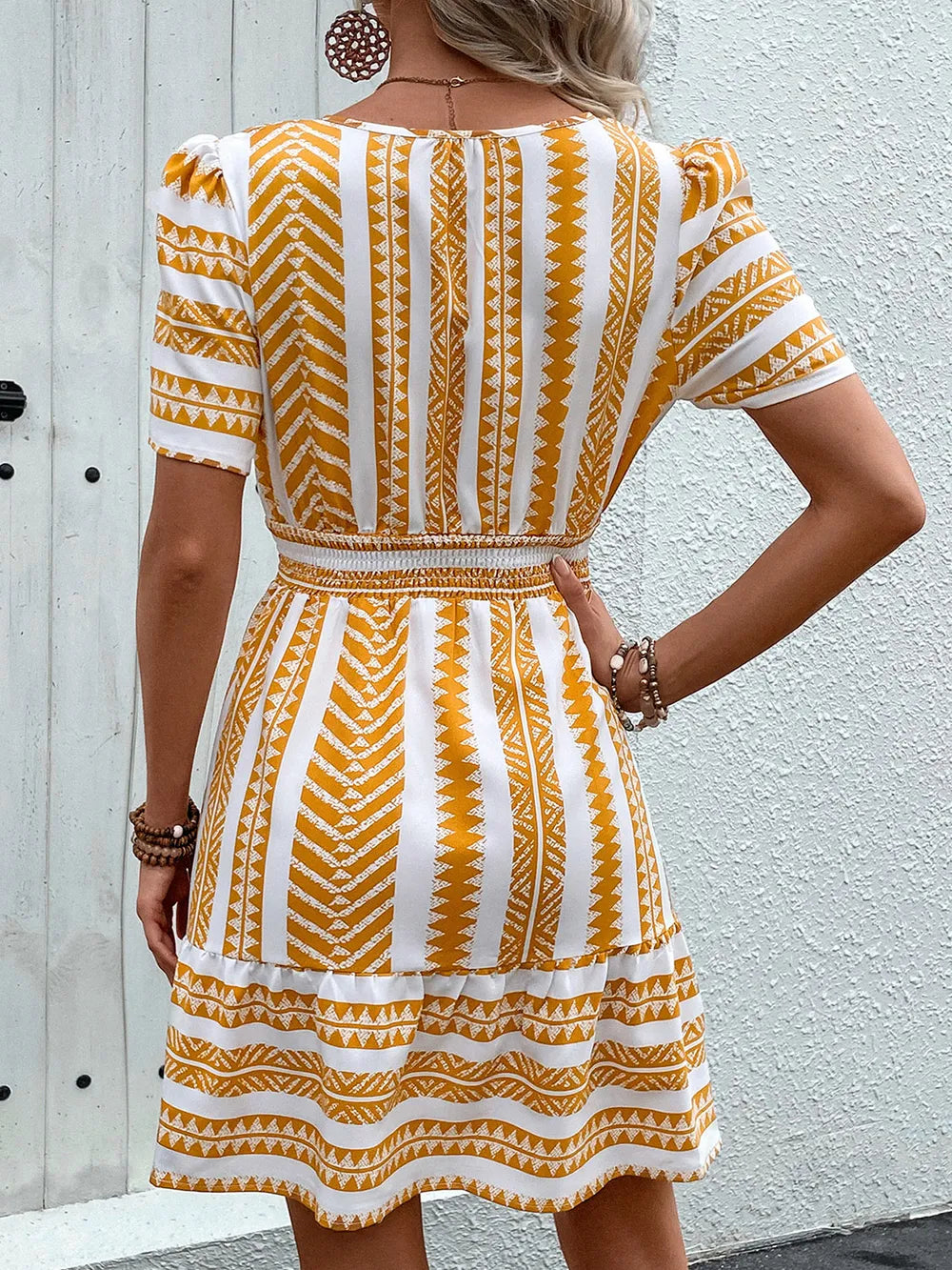 Geometric notched short sleeve mini dress by Plush Fashion Hub, featuring a stylish pattern and modern fit for a trendy look.