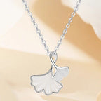 Ginkgo leaf pendant necklace by Shopimist featuring a delicate gold-tone leaf charm on a fine chain.
