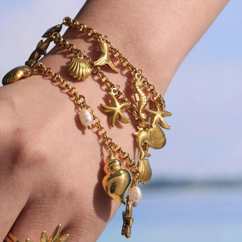 18K gold-plated sea shell charm bracelet with delicate chain and ocean-inspired charms, stylish jewelry by Shopimist.