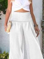 Women's lightweight wide-leg casual trousers with smocked waist, comfortable and relaxed fit, by Trendsi.