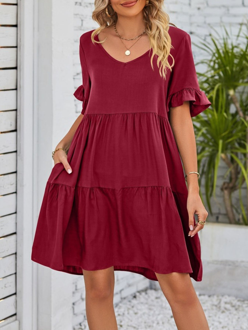 Lightweight rayon mini dress with ruffled sleeves, tiered design, and pockets, perfect for casual wear from Trendsi.