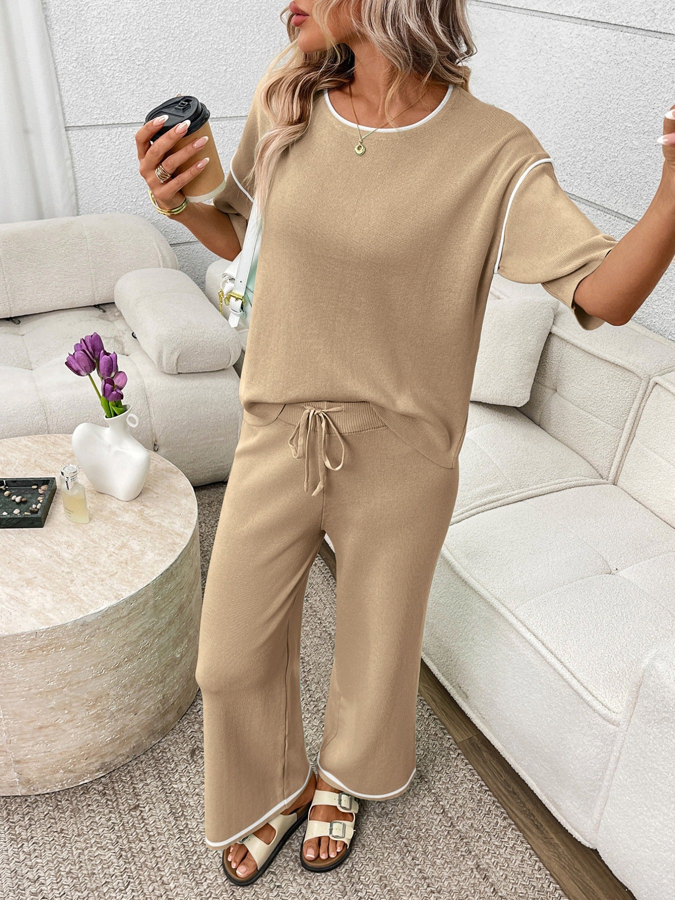 Women's casual two-piece lounge set with round neck top and drawstring pants, trending fashion by Trendsi.