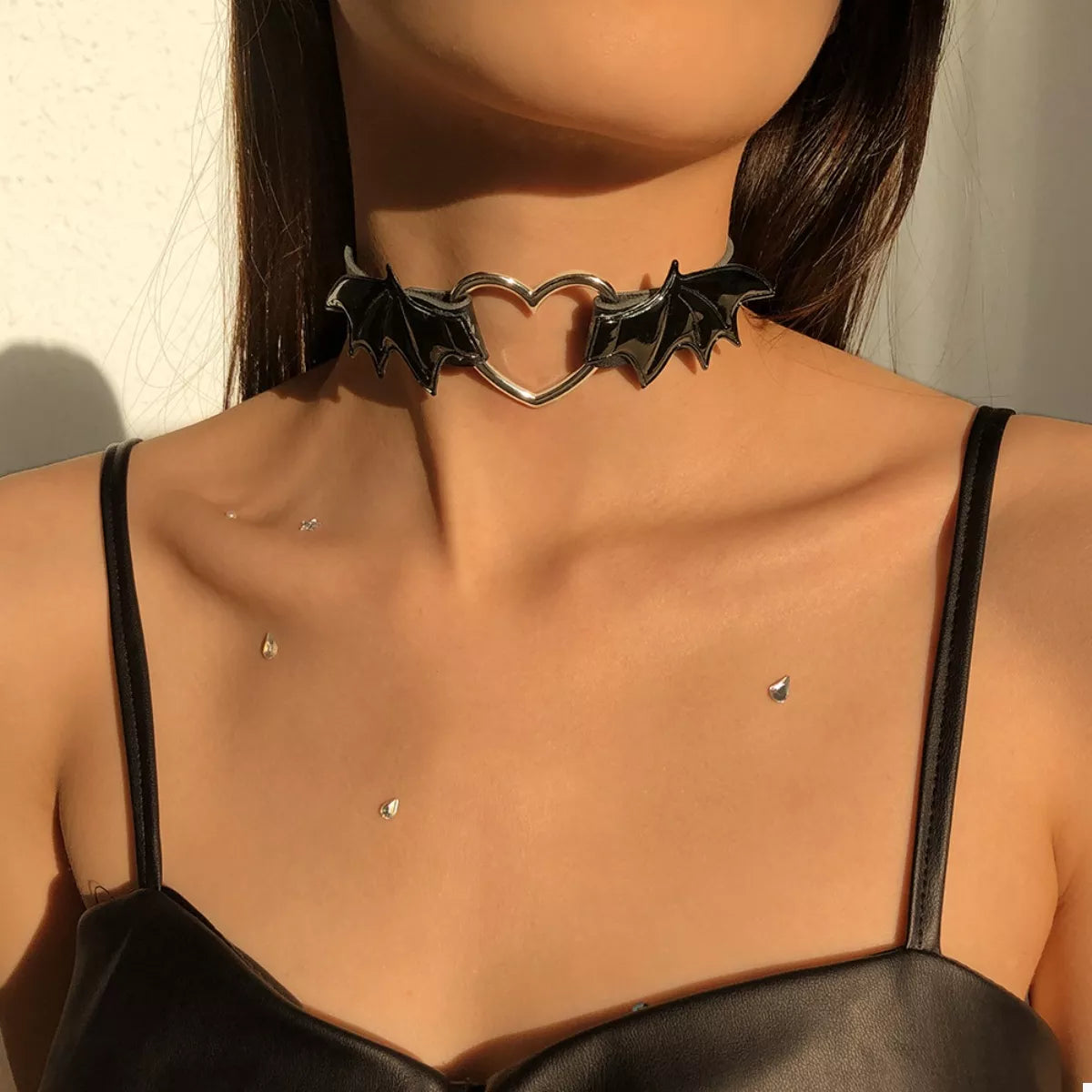 Gothic bat wing heart choker necklace by Plush Fashion Hub featuring black bat wings and a heart charm, stylish and edgy jewelry piece.