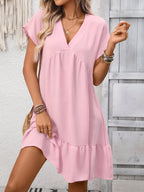 Women's casual V-neck mini dress by Trendsi with ruffle hem and ruched detailing, featuring a relaxed fit and stylish design.