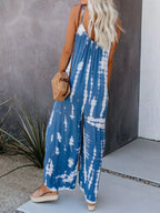 Full size Shopimist tie-dye wide leg jumpsuit with plus size fit, featuring vibrant colors and a relaxed, flowing design.