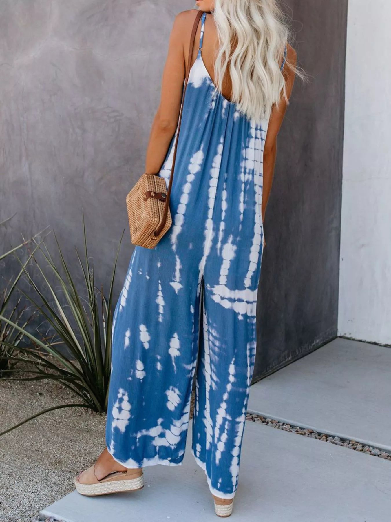 Full size Shopimist tie-dye wide leg jumpsuit with plus size fit, featuring vibrant colors and a relaxed, flowing design.