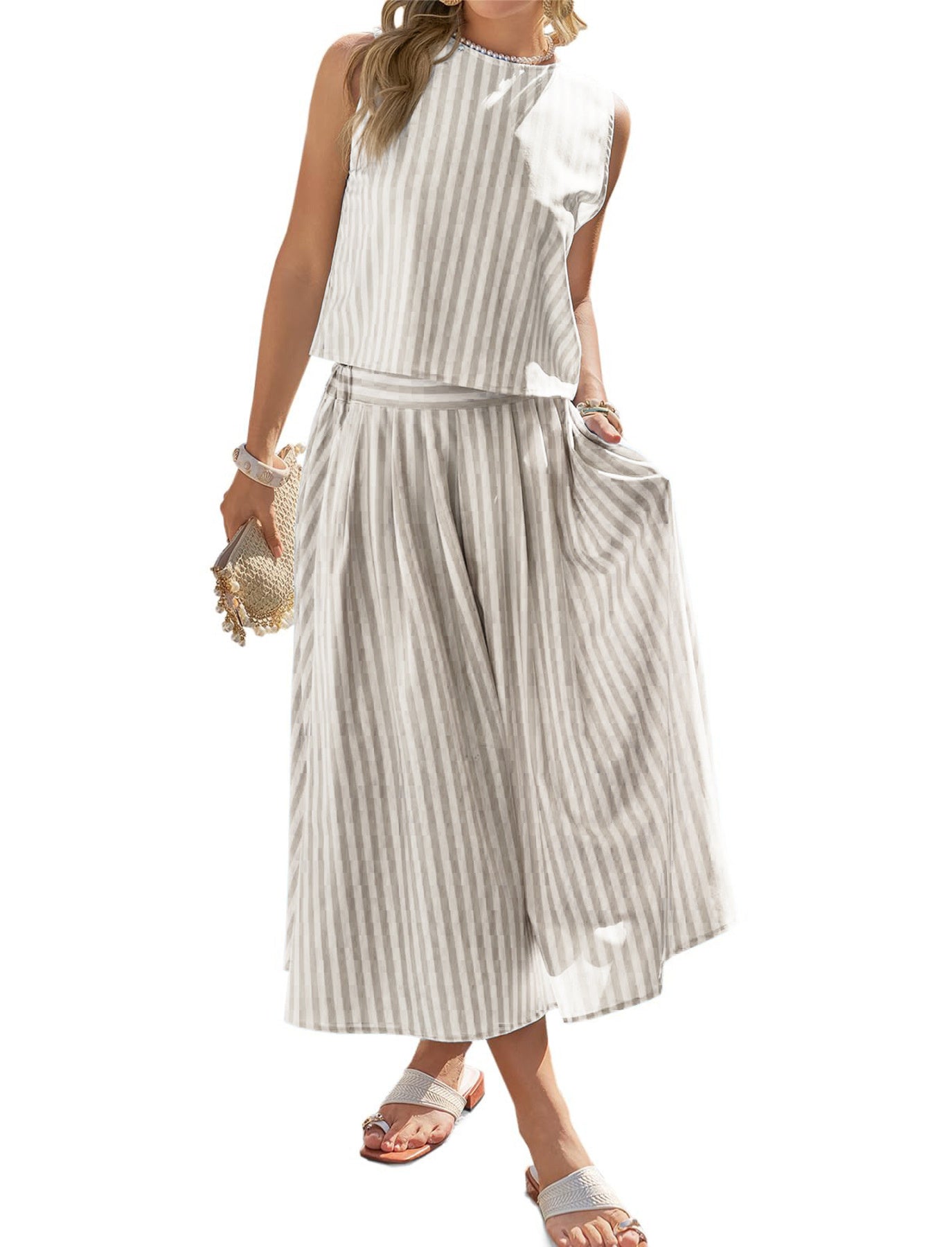 Women's striped sleeveless top and midi skirt two-piece set by Trendsi, shown in a stylish, coordinated ensemble.