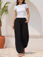 Casual loose fit drawstring waist harem joggers from Trendsi, featuring relaxed style and comfortable fit with tapered legs.