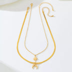 Gold-plated moon and star necklace set featuring two delicate pendants, perfect for layered jewelry styles.