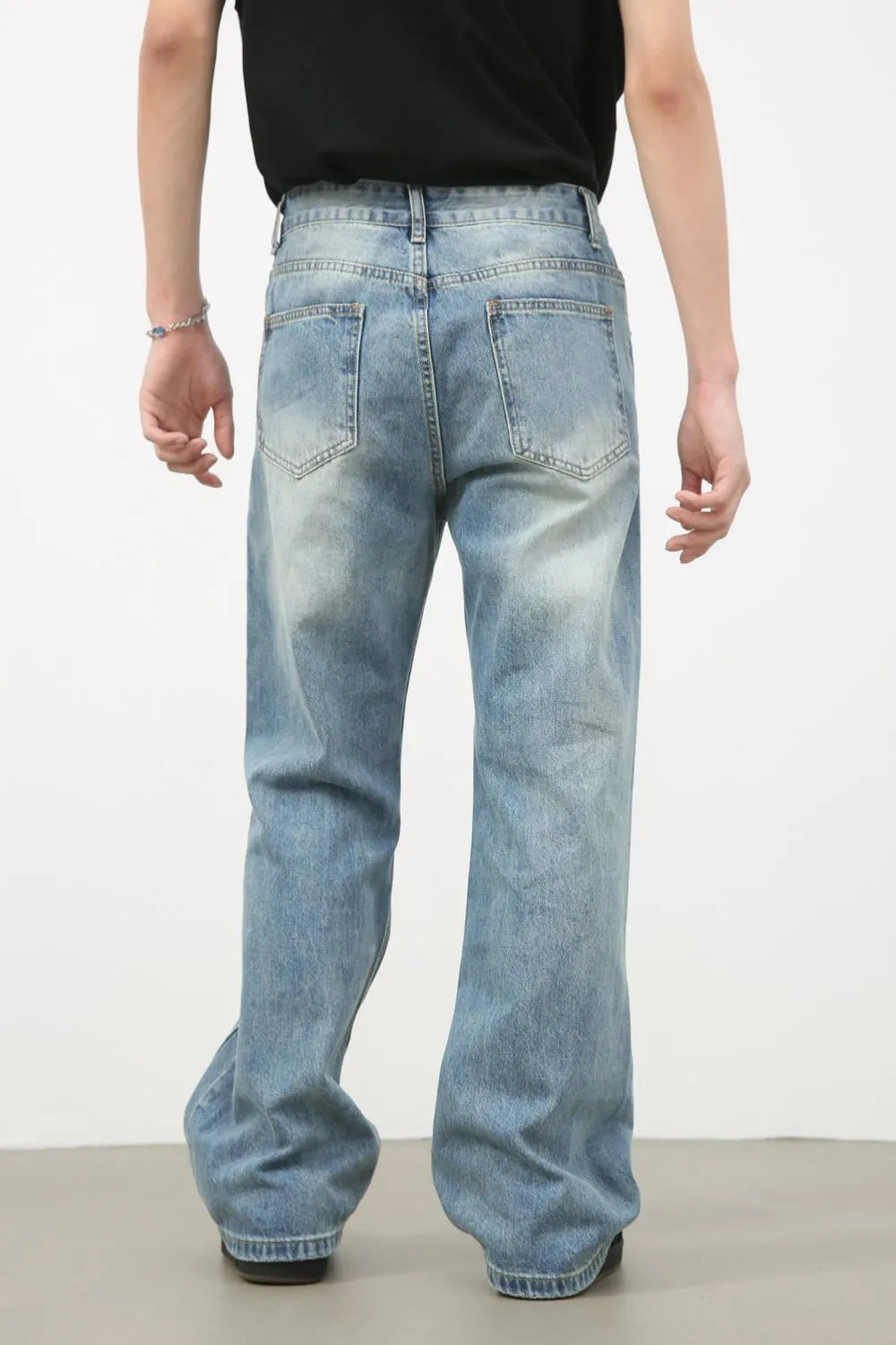 Men's distressed denim jeans by Plush Fashion Shop, featuring a rugged, worn-in look and classic fit, shown in a stylish front view.