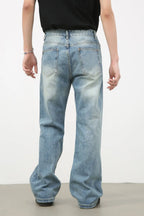 Men's distressed denim jeans by Plush Fashion Shop, featuring a rugged, worn-in look and classic fit, shown in a stylish front view.