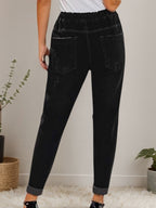 Women’s distressed stretch denim joggers with casual elastic waist from Plush Fashion Hub, featuring a relaxed fit and distressed details.