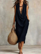 Plus size sleeveless midi dress with cowl neck from Trendsi, featuring a stylish, full-length design perfect for elegant occasions.