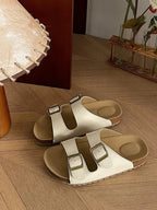 Comfortable flat PU leather sandals with double buckles from Trendsi, featuring a chic design and slip-on style.