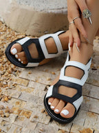 Women's multi-strap gladiator sandals in faux leather with flat soles, featuring a trendy, strappy design for casual wear.