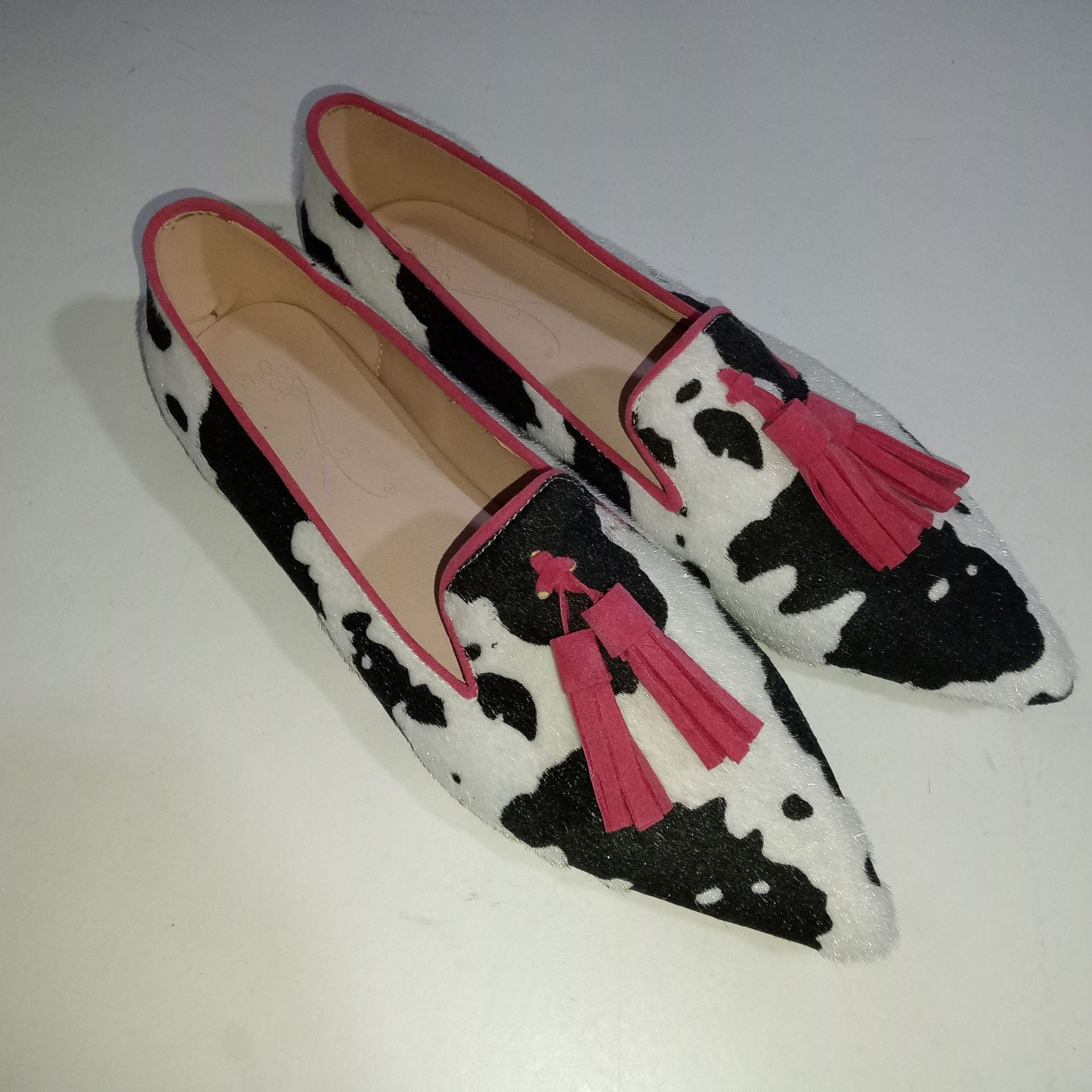 Cow print tassel pumps for women by Plush Fashion Hub, casual slip-on footwear with stylish cow-print and tassel details.