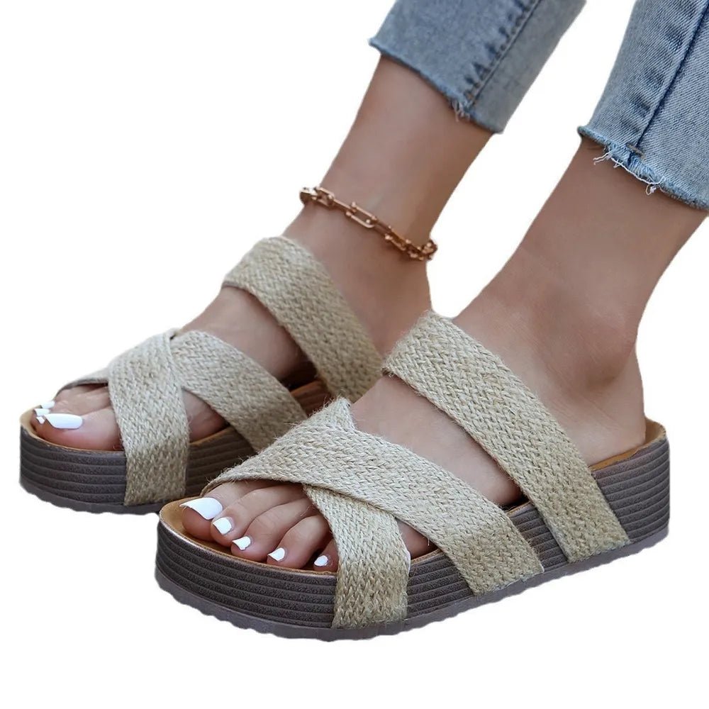 Women's crisscross open-toe platform sandals with faux leather straps and flat soles, designed for comfort and style.