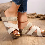Women's crisscross open-toe platform sandals with faux leather straps, featuring a comfortable flat sole and stylish design.