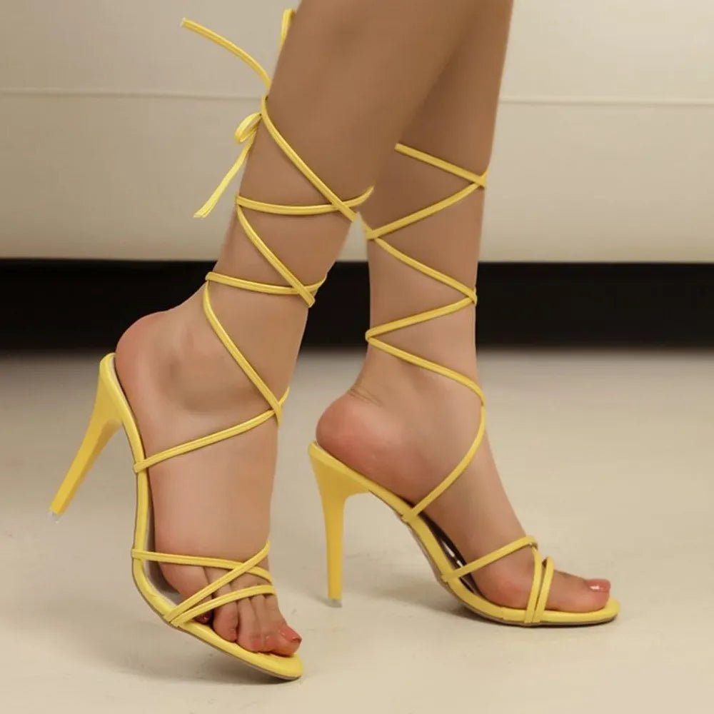 Women's black cross-strap stiletto high heel sandals by Trendsi, elegant evening footwear with slender heels and stylish straps.