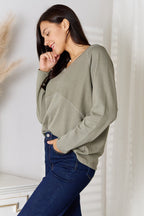Women's V-neck long sleeve cotton blend T-shirt from Trendsi, featuring a classic fit and soft fabric in a neutral color.