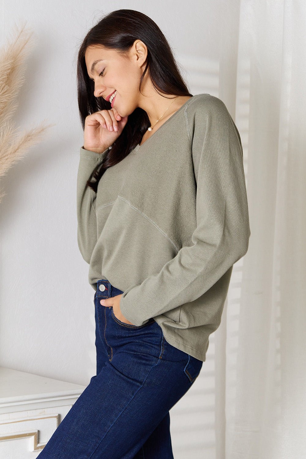 Women's V-neck long sleeve cotton blend T-shirt from Trendsi, featuring a classic fit and soft fabric in a neutral color.