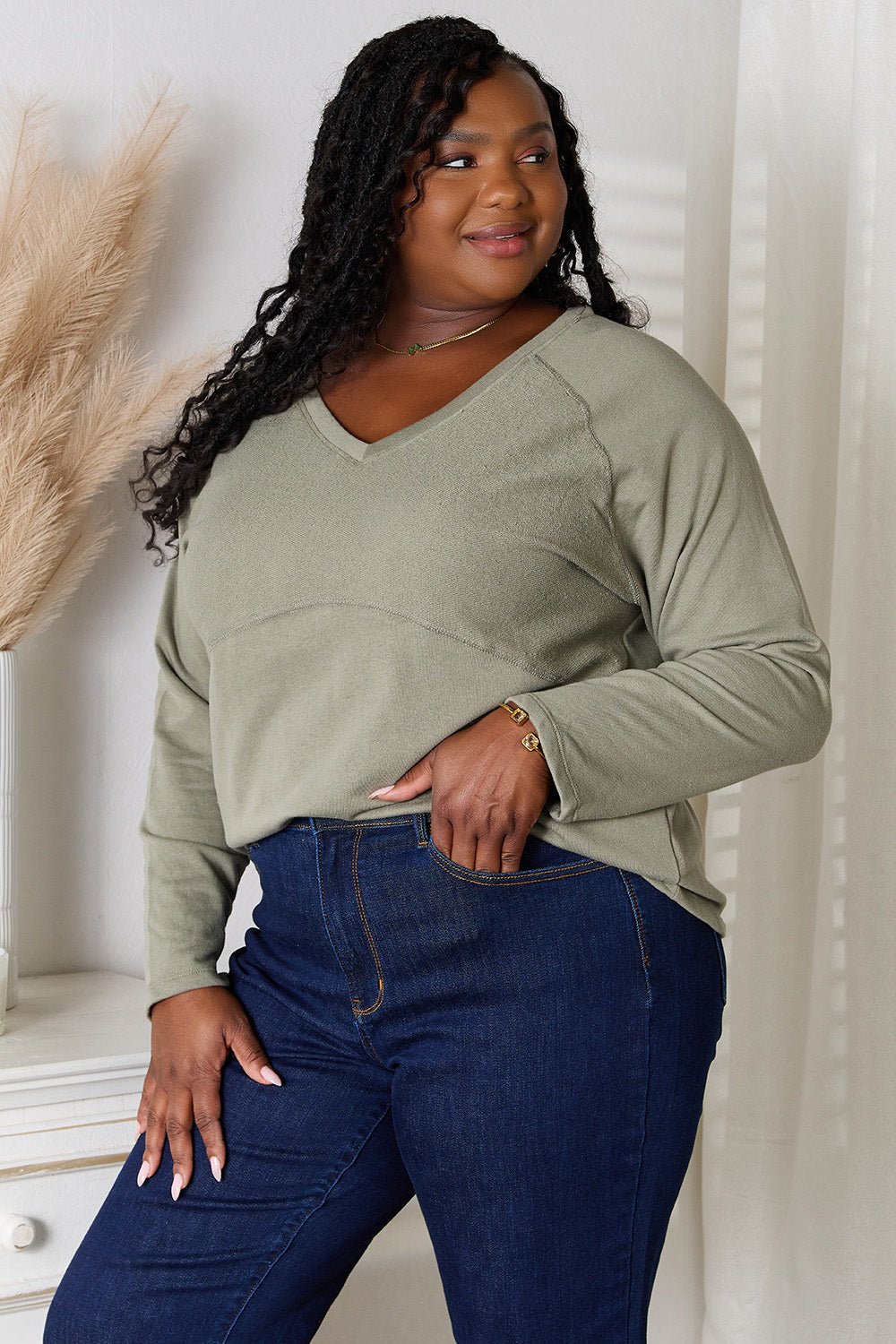 Women's V-neck long sleeve cotton blend T-shirt from Trendsi, featuring a classic fit and comfortable design.