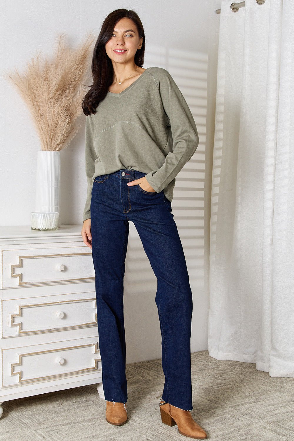 Women's V-neck long sleeve cotton blend T-shirt by Trendsi, shown in a relaxed fit with a classic V-neck and soft fabric.