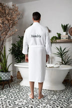 Men's plush waffle spa bathrobe from Plush Fashion Hub, lightweight and absorbent, shown hanging with a relaxed fit and textured fabric.