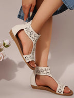 Women's stylish cutout open toe flat sandals made of vegan leather, featuring a trendy design and comfortable fit.