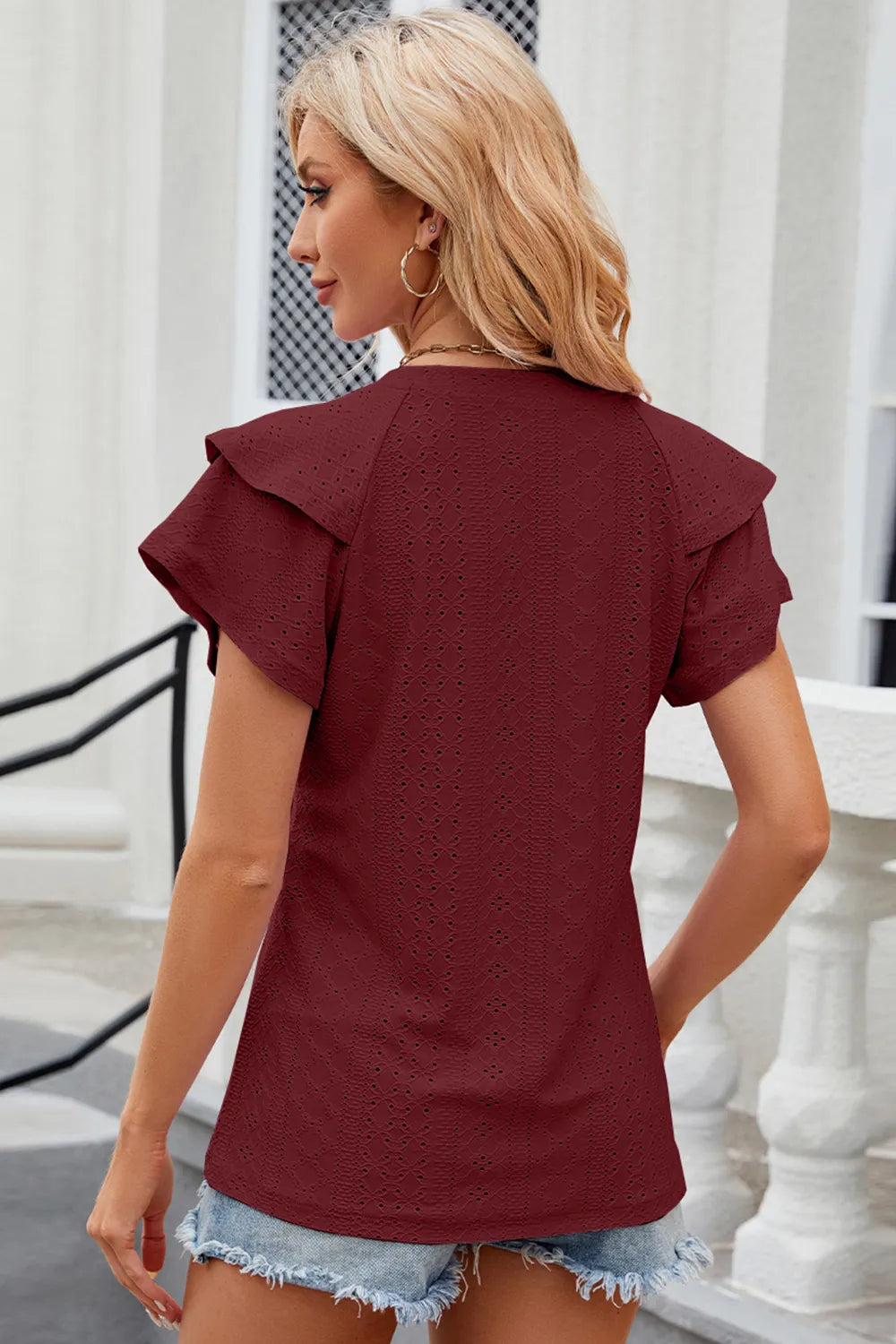Light blue eyelet notched flutter sleeve T-shirt from Trendsi, featuring eyelet details and flutter sleeves, casual and stylish top.