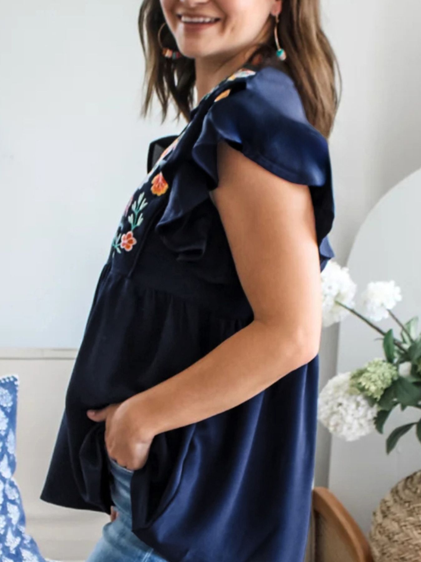 Women's embroidered floral ruffle sleeve blouse by Trendsi, lightweight and elegant top with intricate floral embroidery and ruffle details.