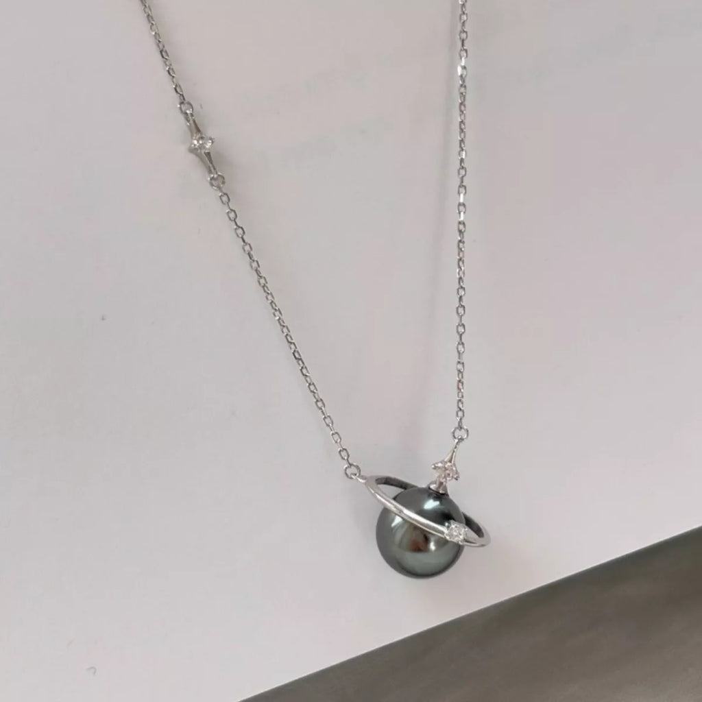 Elegant Planet Pearl Pendant Necklace by Shopimist featuring a lustrous pearl pendant on a delicate chain.