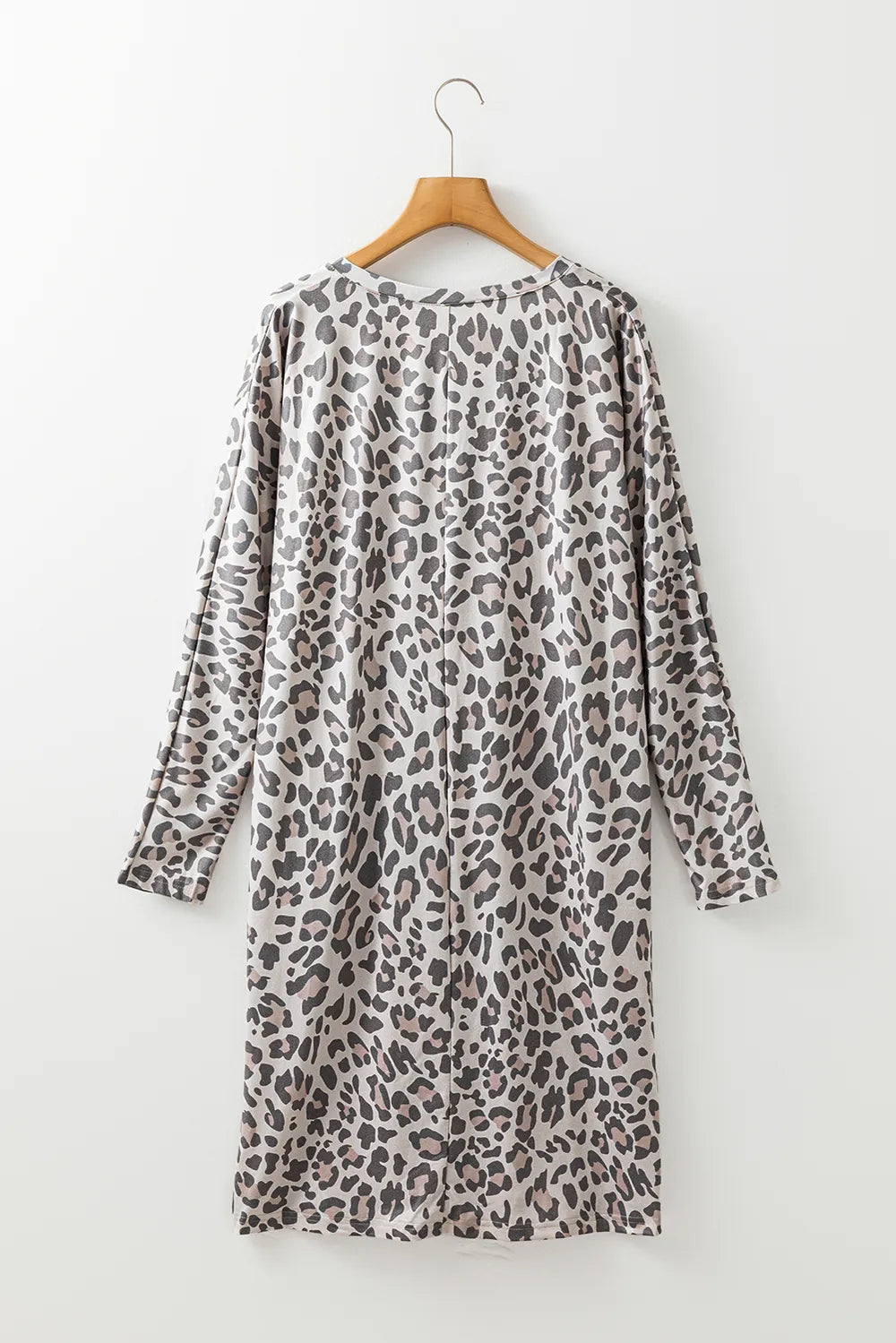 Leopard print V-neck long sleeve dress by Plush Fashion Hub, stylish and fitted with a flowing silhouette.