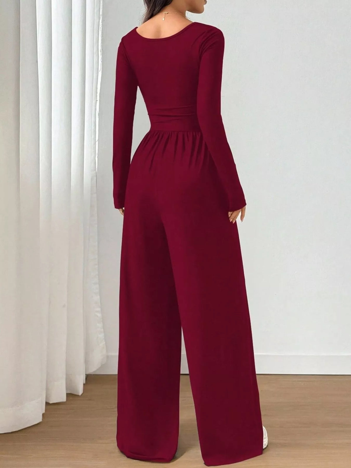 Gray ruched square neck wide-leg jumpsuit by Trendsi, shown on a model with flowing fabric and stylish design.