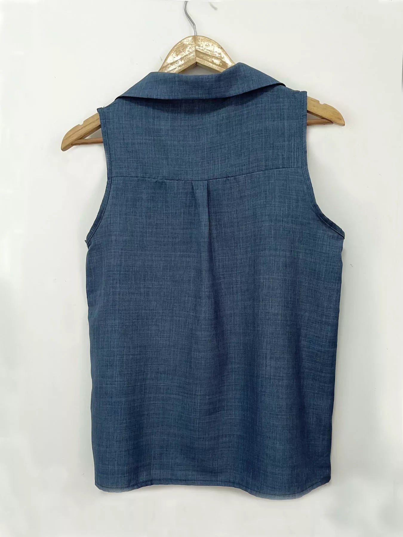 Plus size sleeveless button-up collared top from Trendsi, featuring a stylish full button front and sleeveless design.
