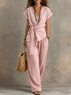 Women's V-neck short-sleeve top and matching pants two-piece set from Plush Fashion Hub, with a relaxed fit and casual style.