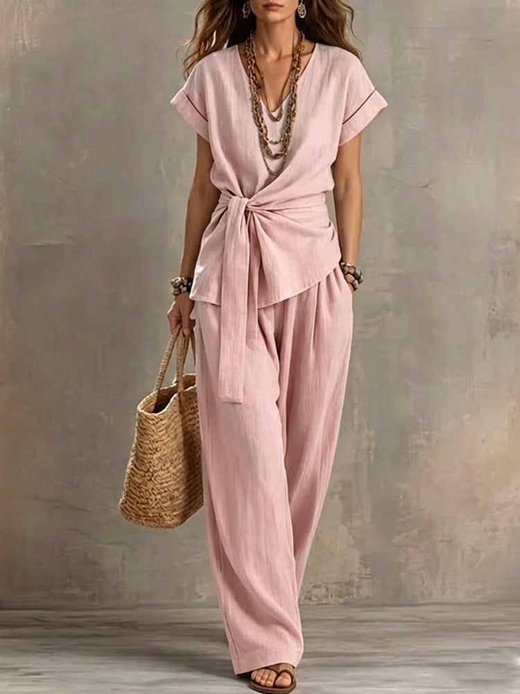 Women's V-neck short-sleeve top and matching pants two-piece set from Plush Fashion Hub, with a relaxed fit and casual style.
