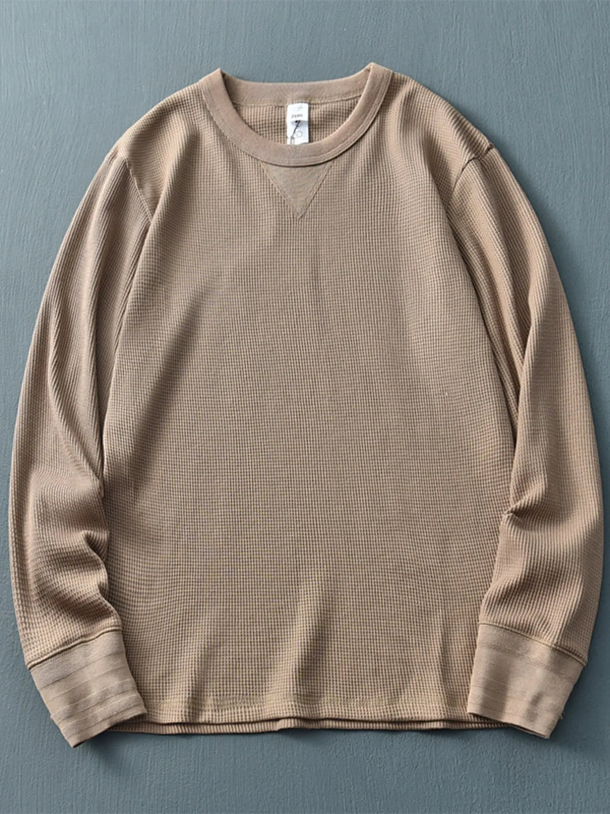 Men's plus size round neck long sleeve T-shirt by Trendsi, showing a comfortable fit and classic design in a neutral color.