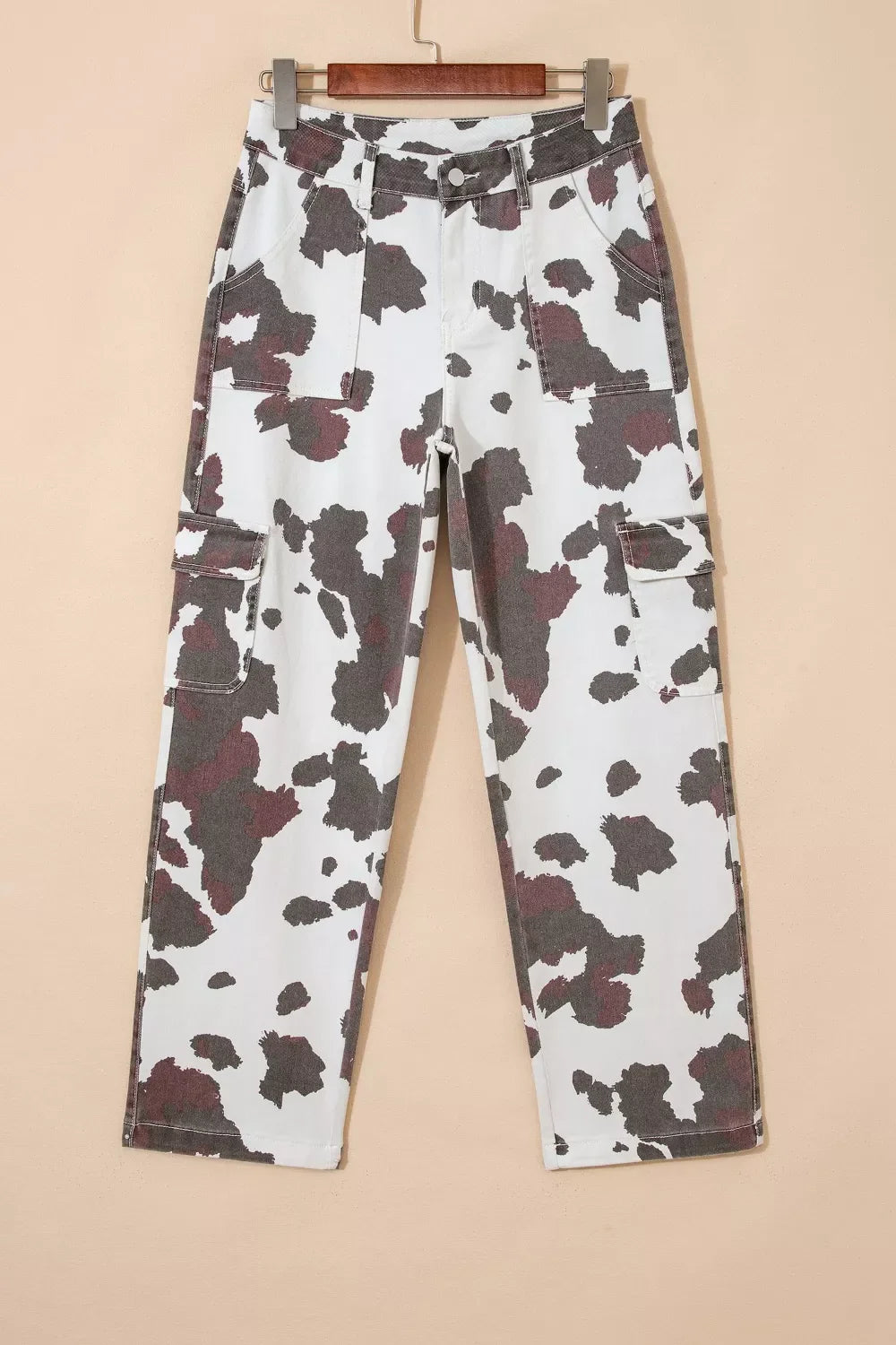 Plush Fashion Hub cow spots printed multi-pocketed jeans with a stylish cow print design and multiple functional pockets.