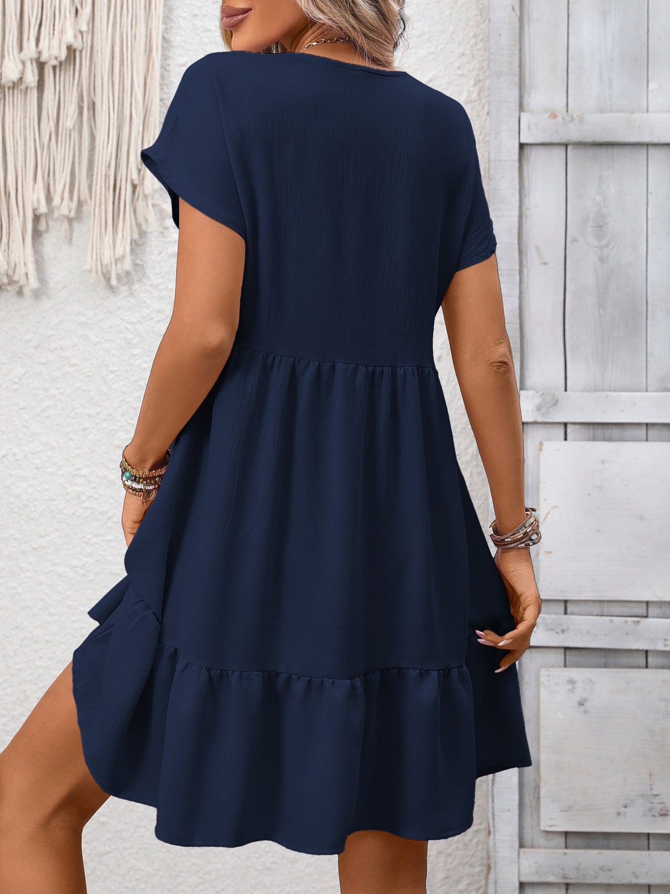 Women's casual V-neck mini dress with ruffle hem and ruched details, stylish and comfortable from Trendsi.