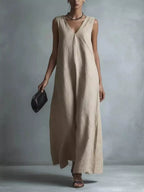 Plus size full-length V-neck sleeveless maxi dress by Trendsi, flowing fabric and elegant design, shown in a full-body front view.