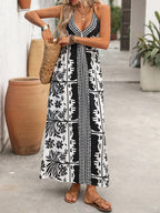 Women’s printed halter neck maxi dress with tie-back detail from Plush Fashion Hub, featuring vibrant floral pattern and flowing silhouette.
