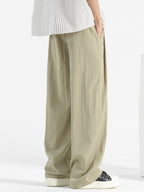 Men's loose fit casual pants with drawstring waist, relaxed comfort trousers in neutral fabric, by Trendsi.