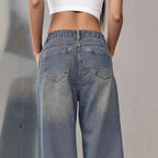 European and American women's washed vintage denim pants with a classic fit and distressed details, styled with casual footwear.