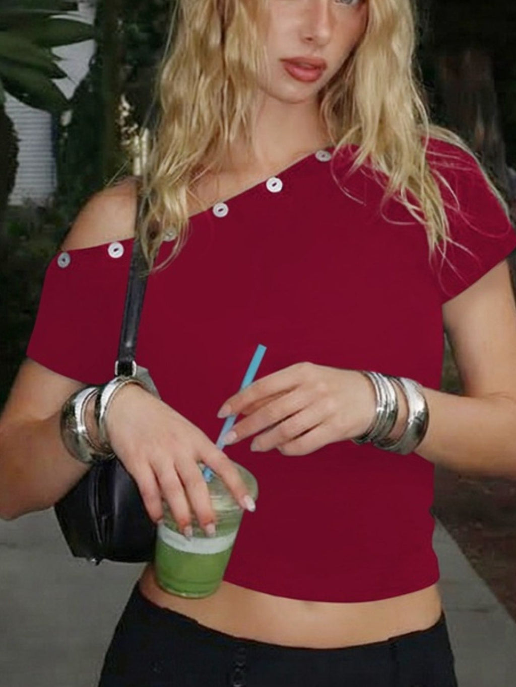 Women's one-shoulder fitted T-shirt with button accents from Trendsi, featuring a stylish design on a soft fabric background.