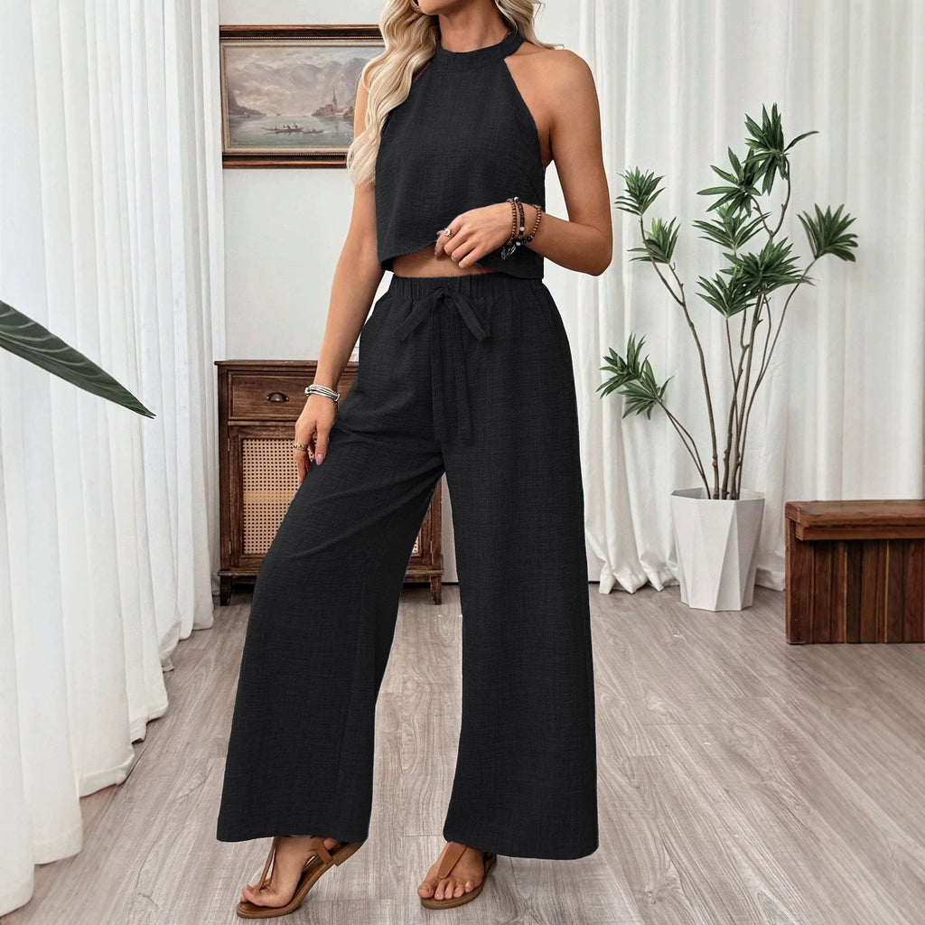 Women's casual two-piece set with halter neck cropped top and wide-leg pants by FitiqueFit, featuring a relaxed style and comfortable fit.
