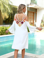 Crochet trim cold shoulder cover-up dress by Trendsi featuring a breathable, stylish design with shoulder cut-outs and intricate crochet details.