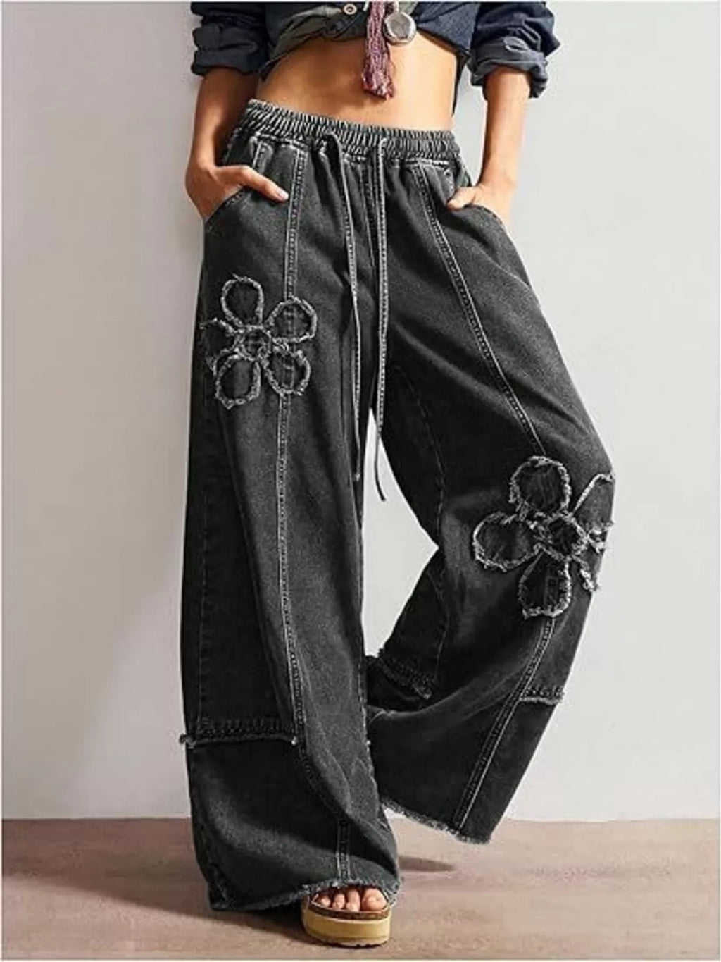 Wide leg jeans with floral appliques from Shopimist, featuring colorful embroidered floral designs on denim fabric.