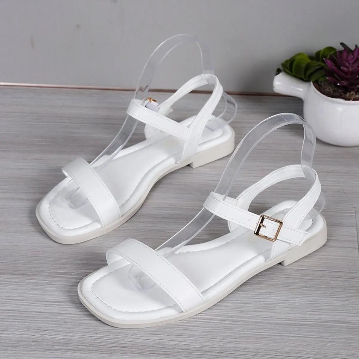 Women's open toe flat sandals by Trendsi featuring comfortable PU leather slide shoes with a chic, stylish design.